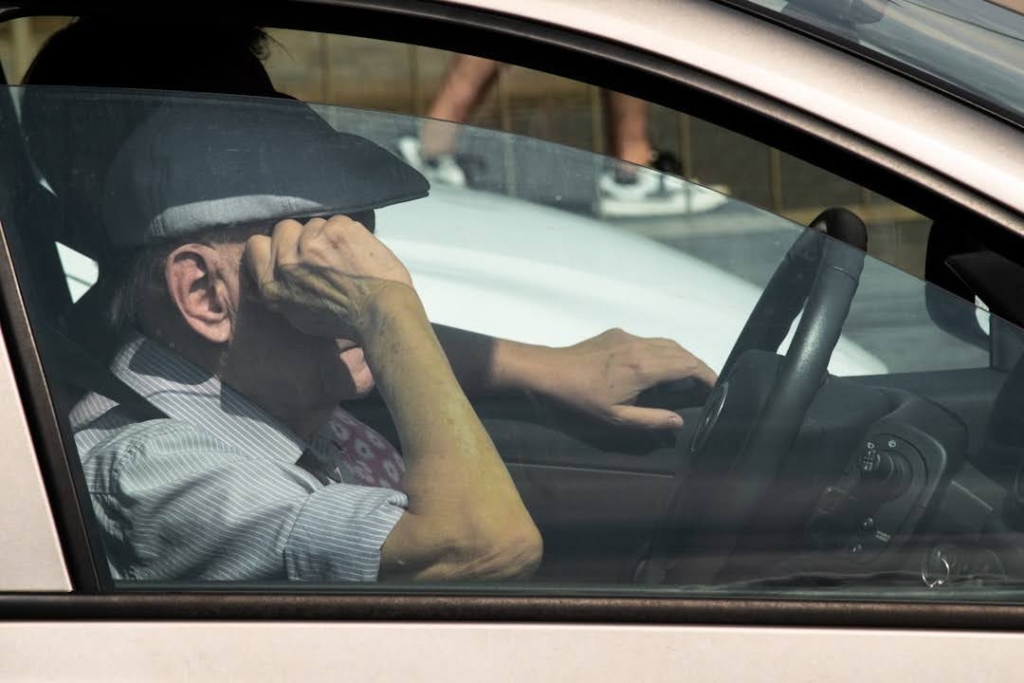 Senior in passenger seat of car